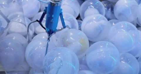 Claw crane picking up white surprise ball Stock Footage 293092991