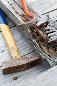 Claw hammer and rusty nails on the old boards Stock Photos