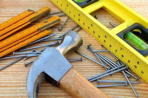 Claw hammer, carpenter meter, water-level and nails Stock Photos