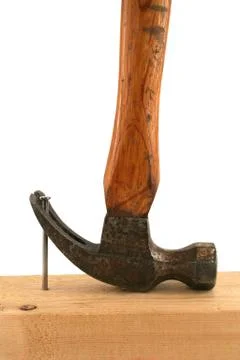 Claw hammer pulling a nail from wood Stock Photos