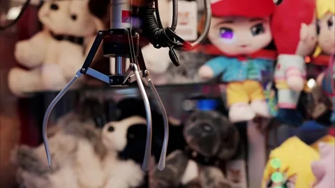 A claw machine game with colorful plush toys in background, arcade game wit.. Stock Footage 339117357