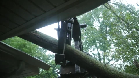 A Claw Machine Holding Tree Off Roof after Storm 库存影片 344825908