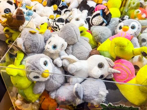 Claw machine with plush toys. Amusement, play, childhood and leisure in an .. Stock Photos