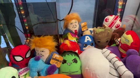 Claw Machine with Plush Toys Including Trump Doll Stock Footage 289401233