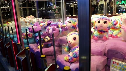 Claw machine Toy Arcade game filled with unicorns childrens toys Stock Footage