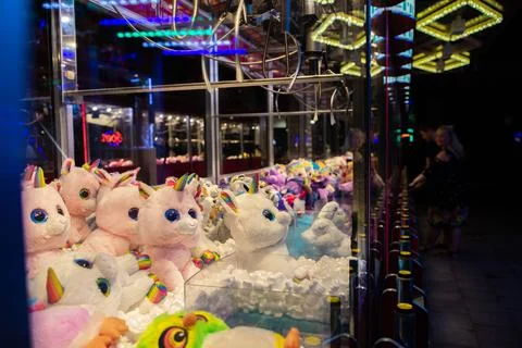 Claw machine Toy Arcade game filled with unicorns childrens toys Stock Photos