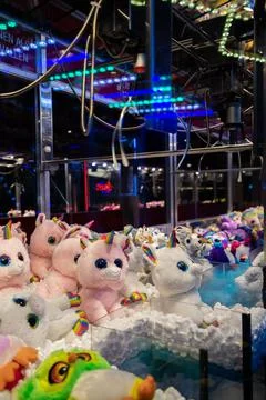 Claw machine Toy Arcade game filled with unicorns childrens toys Stock Photos