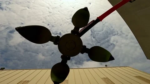 Claw on scrap metal seen from below with cloudy sky as it opens and closes its Stock Footage 171962589