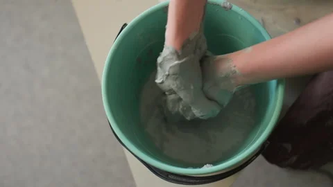 Clay art process. Hands mix wet clay vigorously. Involving energetic hands and Stock Footage 345523782