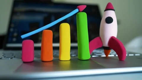 Clay Bar Graph and Rocket on Laptop Symbolizing Growth, Colorful clay bar g.. Stock Footage 304881700