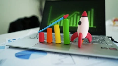 Clay Bar Graph and Rocket on Laptop Symbolizing Business Growth, Colorful c.. Stock Footage 304881757