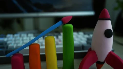 Clay Bar Graph with Rocket Symbolizing Growth, Colorful clay bar graph with.. Stock Footage 304881198