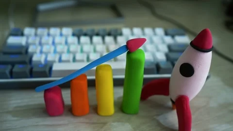 Clay Bar Graph with Rocket Symbolizing Growth, Colorful clay bar graph with.. Видео 304881285