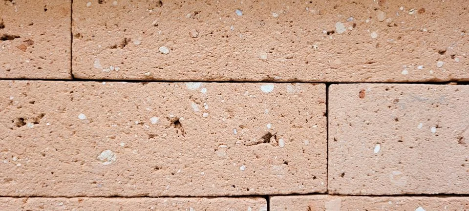 Clay bricks background in house masonry wall Stock Photos