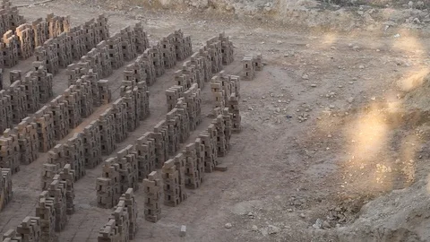 Clay bricks left for drying in sunlight at a local brick factory. Stock Footage 86658971