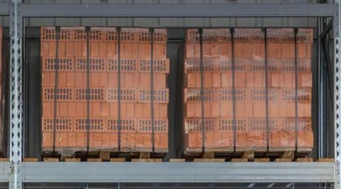 Clay bricks stock pallets stacking at the construction site. Stock Photos