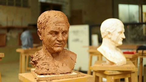 Clay bust face being destroyed by a huge stick Stock Footage 124981128