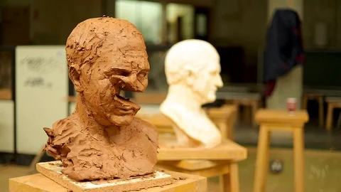 Clay bust face being destroyed by a huge stick Stock Footage