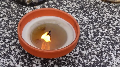 A clay candle burning on a grave. Video stock 295076148