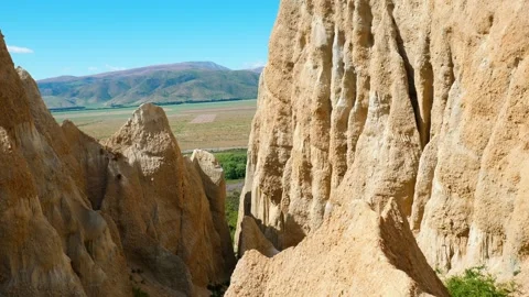 Clay Cliffs with hills in background Stock Footage 260367317