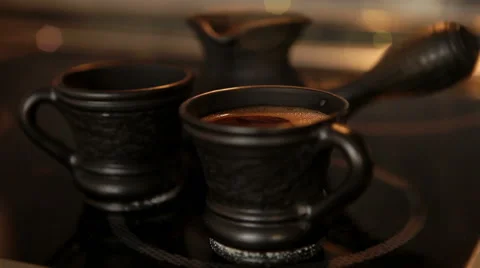 Clay coffee set Cezve and two cups with steaming coffe Stock Footage 58892854