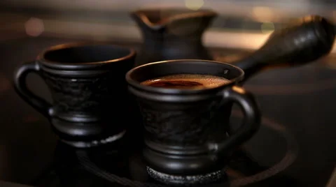 Clay coffee set Cezve and two cups with steaming coffe Stock Footage 62514958