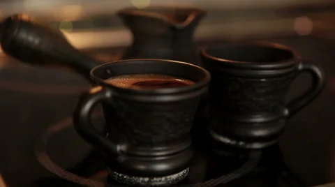 Clay coffee set Cezve and two cups with steaming coffe Stock Footage 68092804