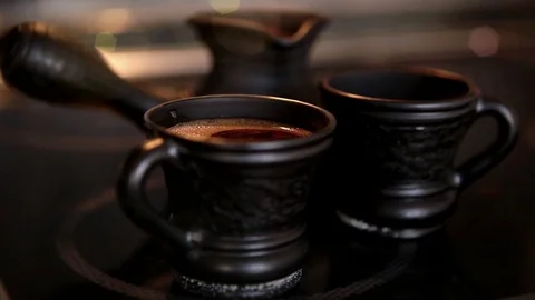 Clay coffee set Cezve and two cups with steaming coffe Stock Footage 69778173