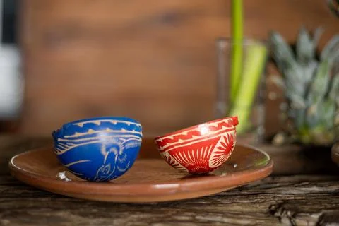 Clay copitas resting on rustic ceramic plate, traditional mezcal drinking v.. Photos