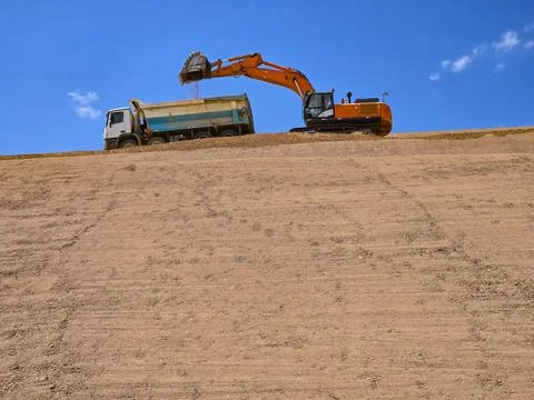 Clay cover construction process in sanitary landfills using heavy machinery Stock Photos
