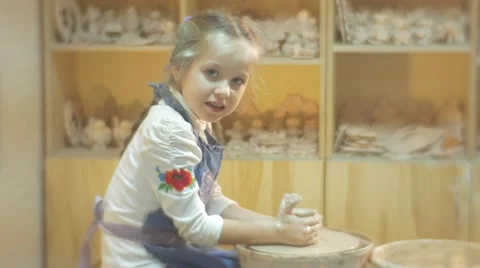 A Clay Craft is Made by a Laborious Blonde Girl Who Learns the Old Craft of Stock Footage 59129636