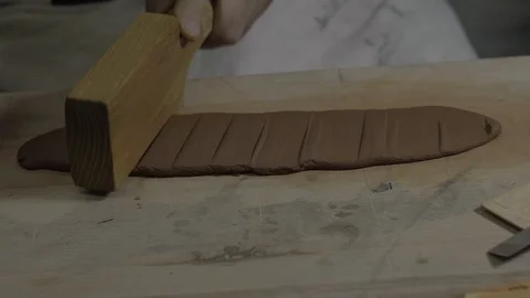 Clay craftsman flatten clay by beating it with a wooden hammer. teapot Yixing Stock Footage 119066048