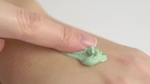 Clay cream mask applied on hand. Green cream mask applying on hand skin. Sw.. Stock Footage 260894845