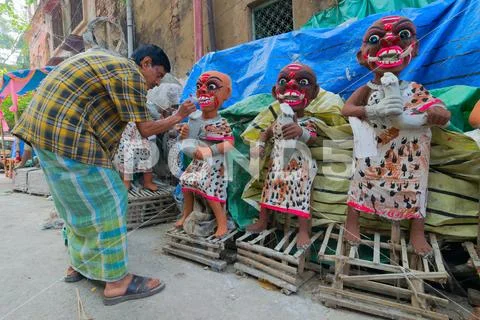 Clay idol of female demons being prepared Stock Photos