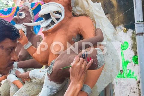 Clay idol of female demons being prepared Stock Photos