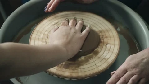 Clay master class on a potter's wheel. Hands of a student and a teacher. Hobbies Video stock 212616742