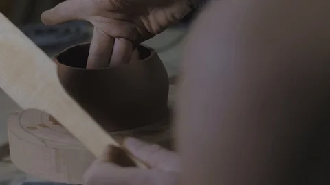 A clay master makes the mold for the clay teapot with a special wooden spatula Stock Footage 119066006