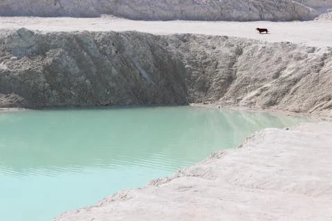 Clay mining. Beautiful background of white clay. Blue water. Stock Photos