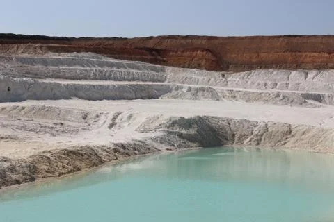 Clay mining. Beautiful background of white clay. Blue water. Photos