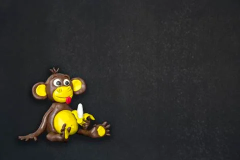 Clay monkey on black background Stock Photos