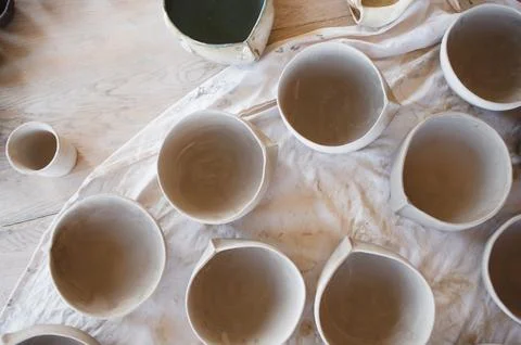 Clay plates on the table, pottery work Stock Photos