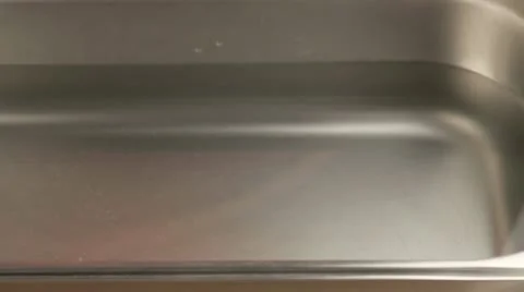 A clay pot with an inverted lid being placed in water Stock Footage 24657828