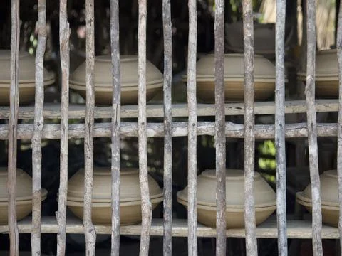 Clay pots drying on rustic shelves 스톡 사진