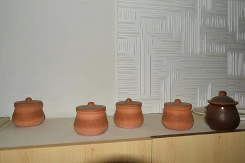 Clay pots on a kitchen shelf Stock Photos