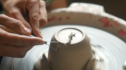 Clay pottering A man makes a pot Traditional potter wheel close up Hands Tools Stock Footage 104441963
