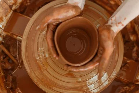 Clay pottery workshop, the process of making ceramic crockery. Woman hand hol 스톡 사진
