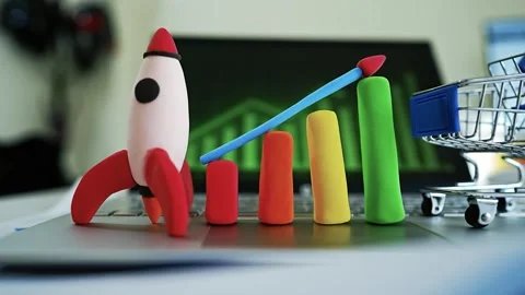 Clay Rocket and Bar Graph Symbolizing Growth, Colorful clay rocket and bar .. Stock Footage 304878556