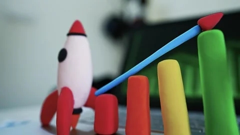 Clay Rocket and Bar Graph on Laptop, Clay rocket and bar graph representing.. Stock Footage 304878808
