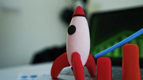Clay Rocket and Bar Graph on Laptop, Clay rocket and bar graph representing.. Stockbeeldmateriaal 304879068