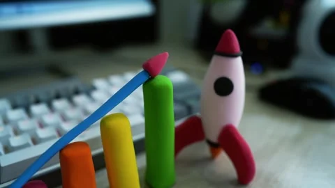 Clay Rocket and Bar Graph on Desk, Colorful clay rocket and bar graph on a .. Vídeos de archivo 304881477